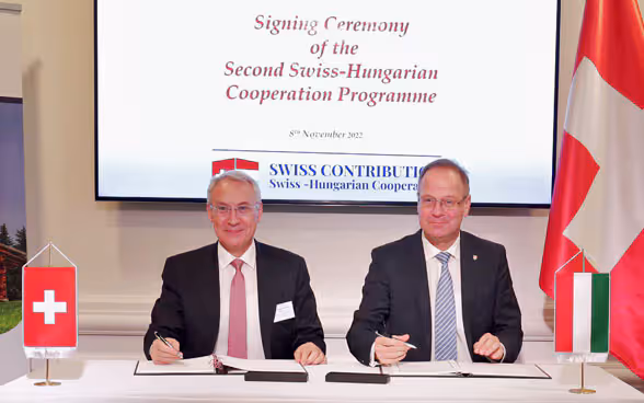 Der Schweizer Botschafter Jean-François Paroz und der ungarische Minister für Regionalentwicklung, Dr. Tibor Navracsics, unterzeichnen das Rahmenabkommen für das neue schweizerisch-ungarische Kooperationsprogramm; Budapest, 8. November 2022.