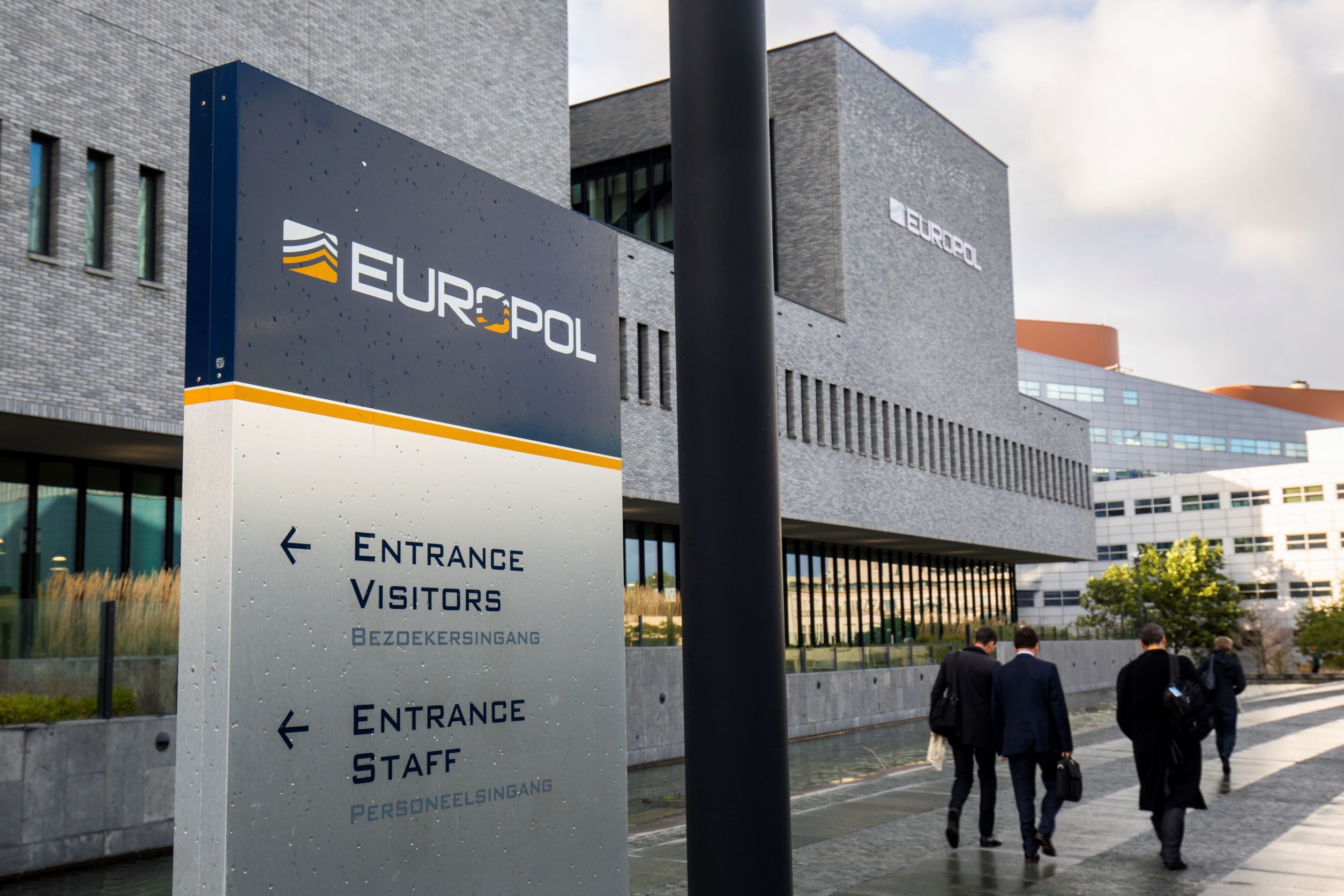 Passers-by in front of Europol headquarters in The Hague.
