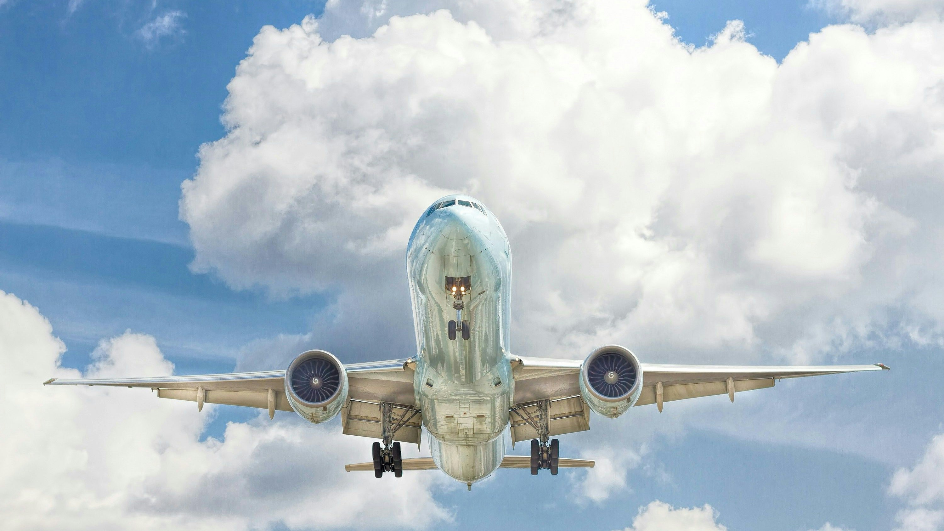 A plane with clouds in the background.