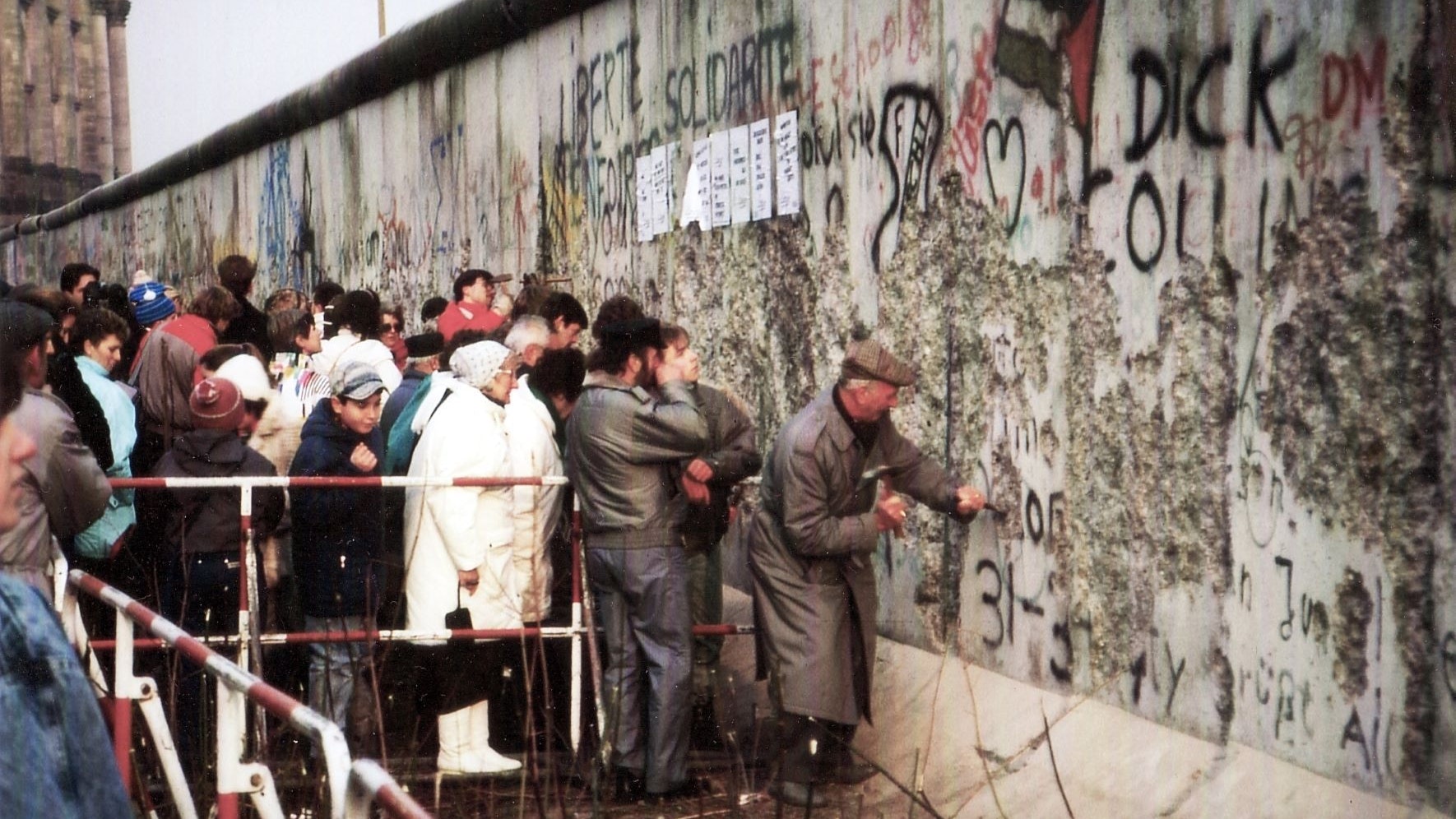 Fall of the Wall: the Berlin Wall between the Reichstag building (a small part of which can be seen in the background) and the Brandenburg Gate.
